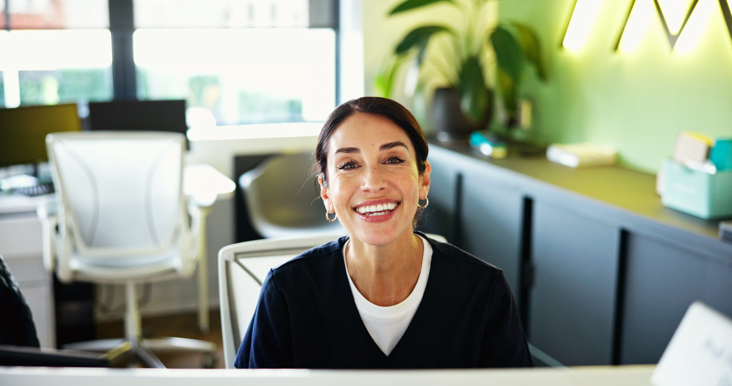 Clinic, receptionist and portrait of woman in office for medical service, appointment and administration. Healthcare, happy and dental assistant at front desk for insurance, schedule and information