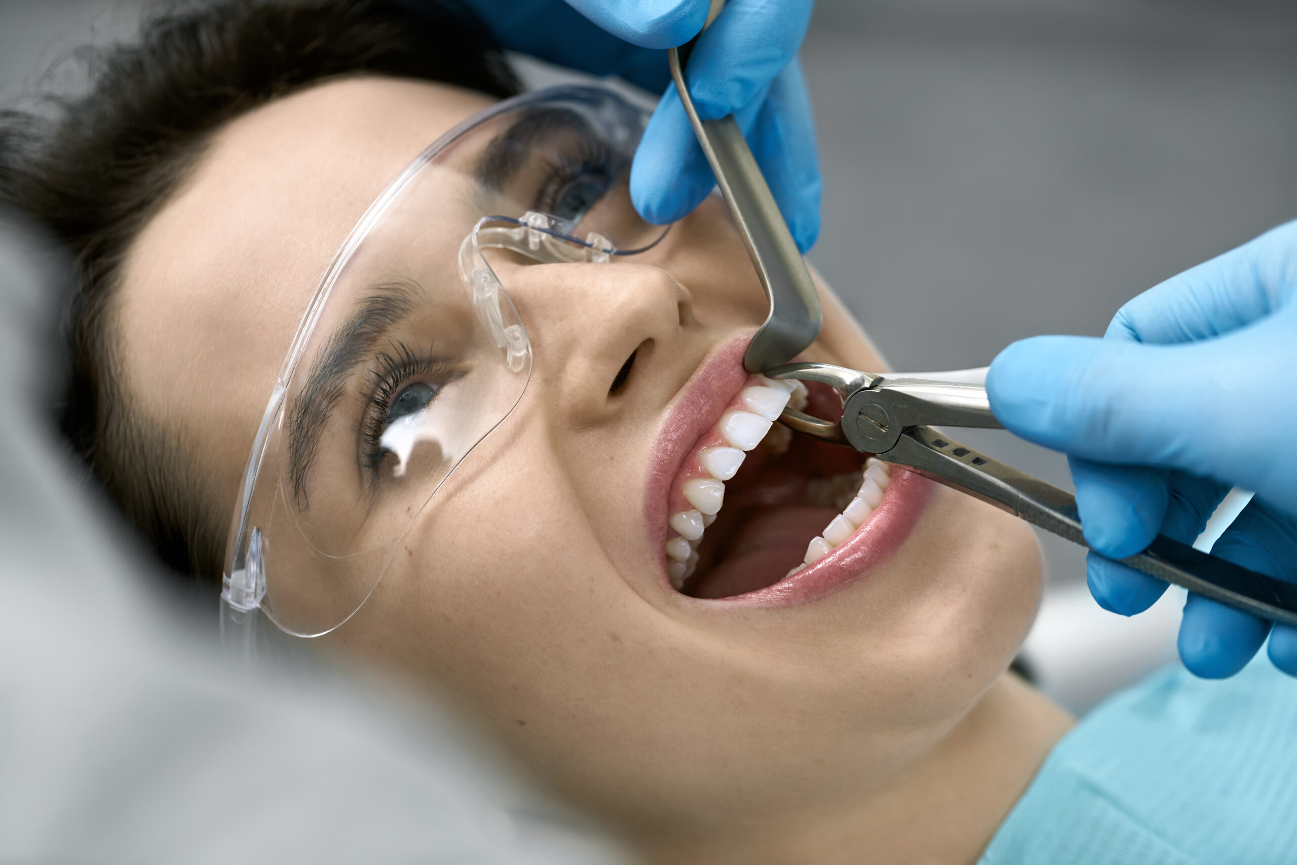 Pretty woman's teeth treatment in dental clinic