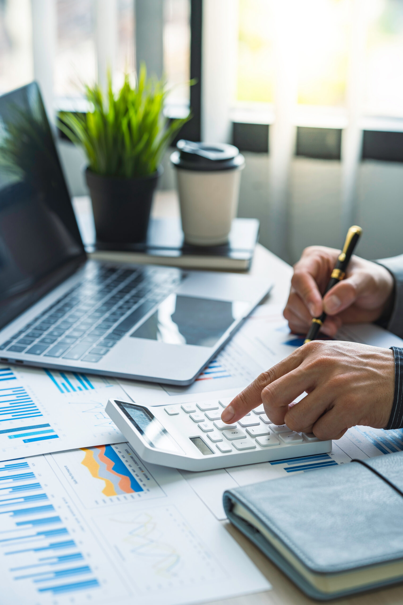 Business accounting concept, Business man using calculator with computer laptop, budget and loan paper in office.